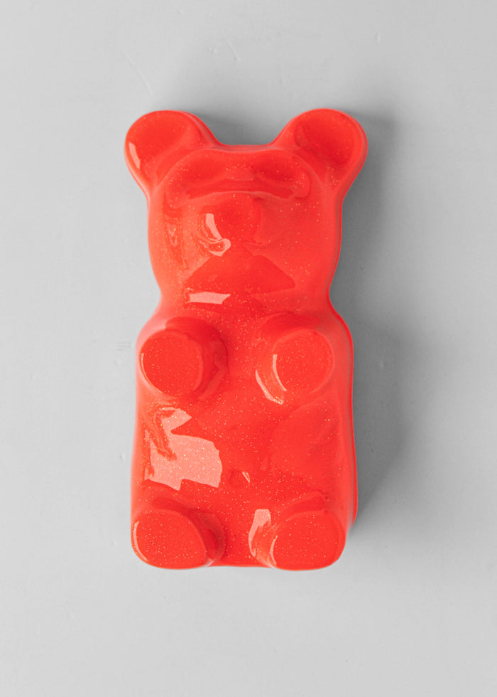 Fluorescent Orange Gummy Bear by Olivia Bonilla — original plaster, automotive paint, and resin sculpture, 5×10×5 in. Midnight Gallery.
