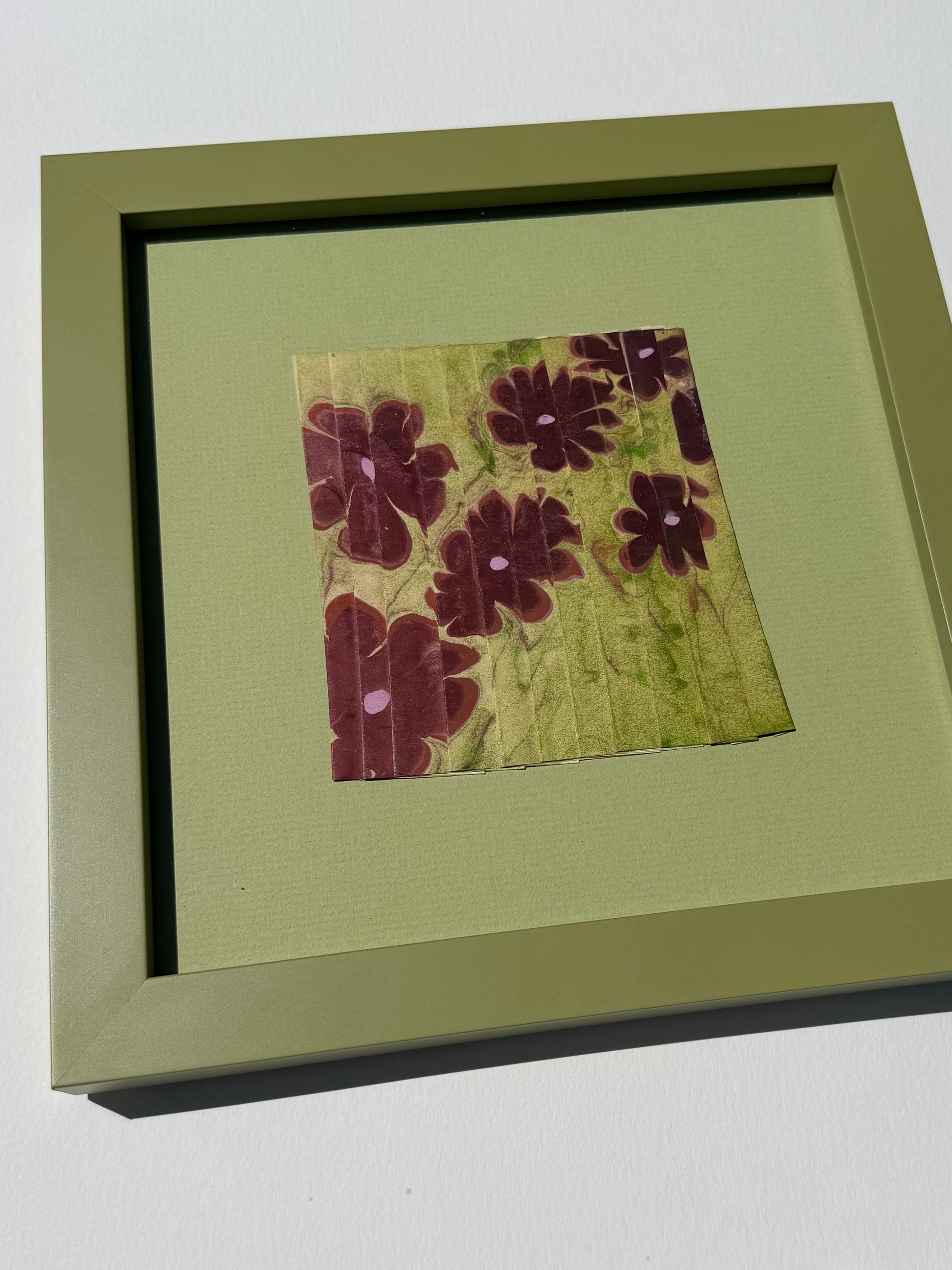 Framed Ebru Pleat III by Morgan Elvington Walker — original marbling on pleated newsprint paper, 5×5 in, framed. Midnight Gallery.