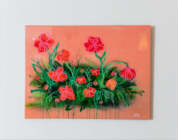 Framed painting of red flowers on a peach background