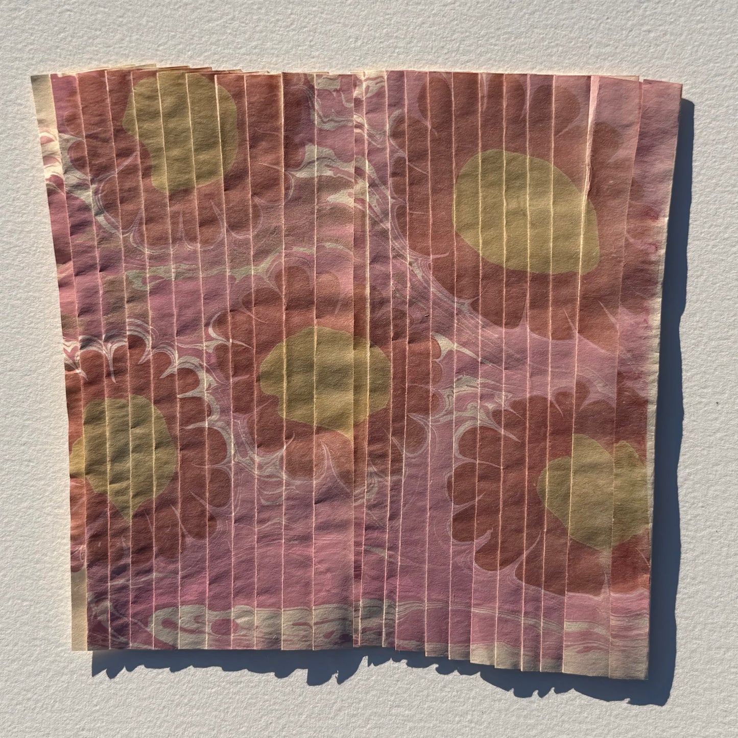 Ebru Pleat III by Morgan Elvington Walker — original marbling on pleated newsprint paper, 10×8.75 in. Midnight Gallery.