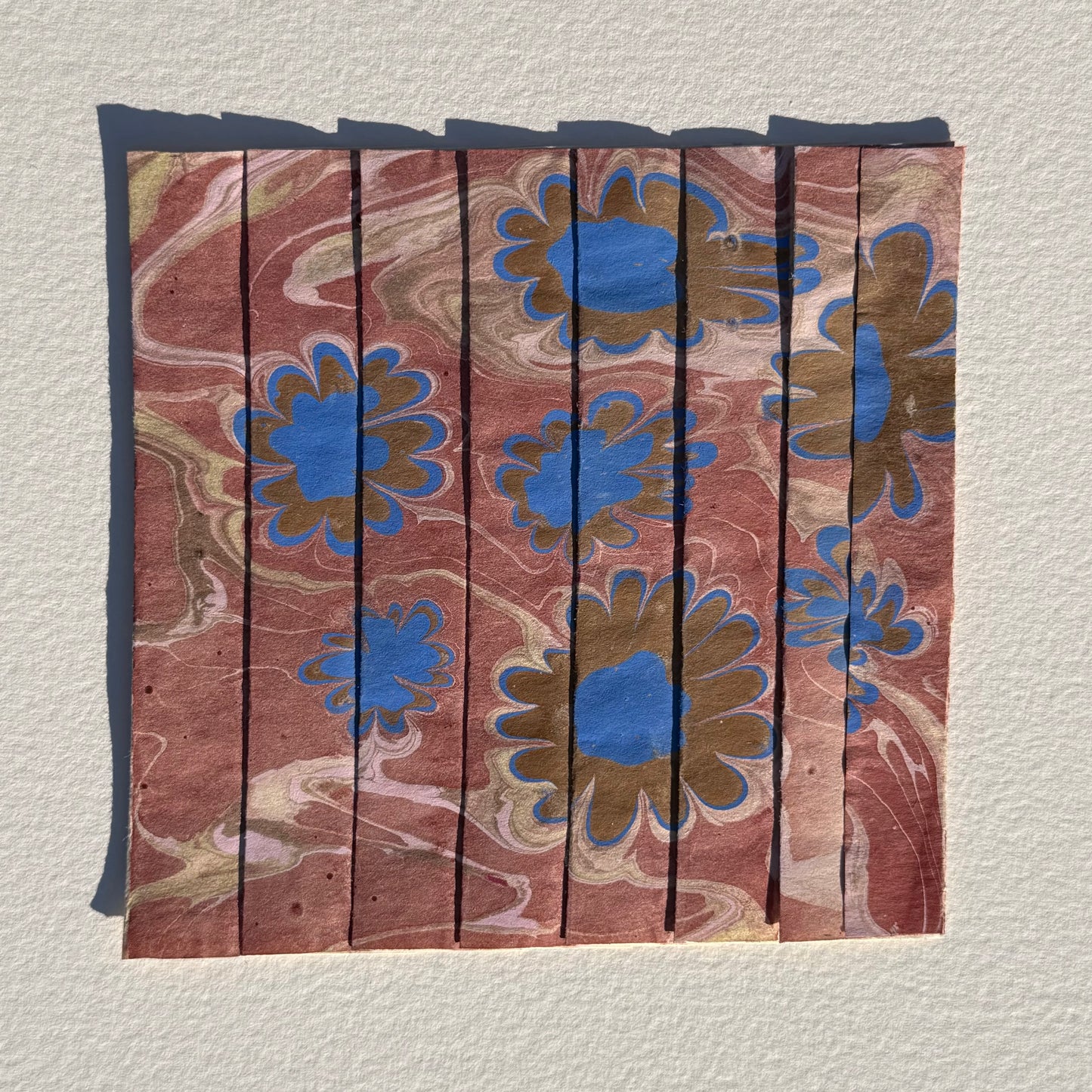 Ebru Pleat IV by Morgan Elvington Walker — original marbling on pleated newsprint paper, 6×6 in. Midnight Gallery.