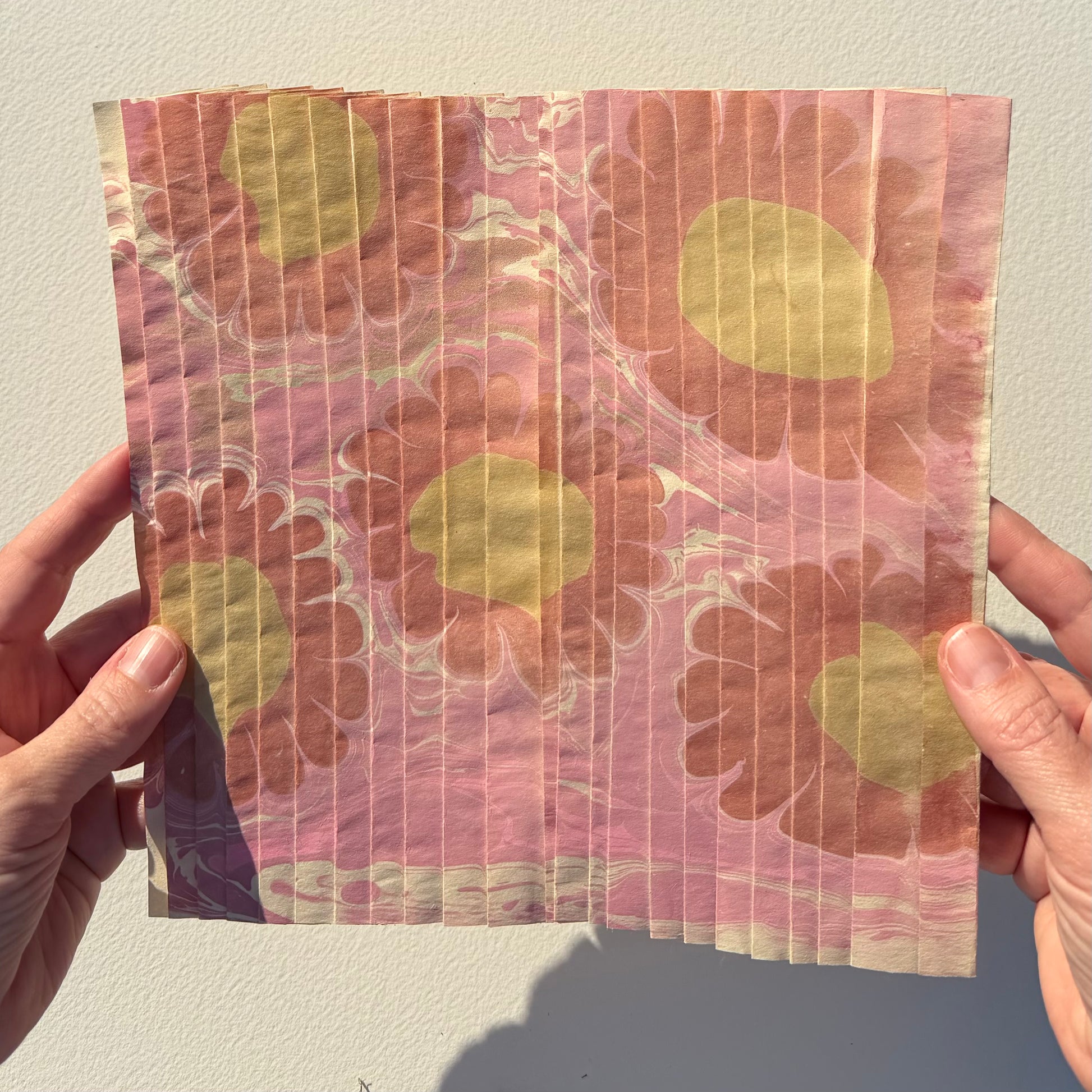 Ebru Pleat III by Morgan Elvington Walker — original marbling on pleated newsprint paper, 10×8.75 in. Midnight Gallery.