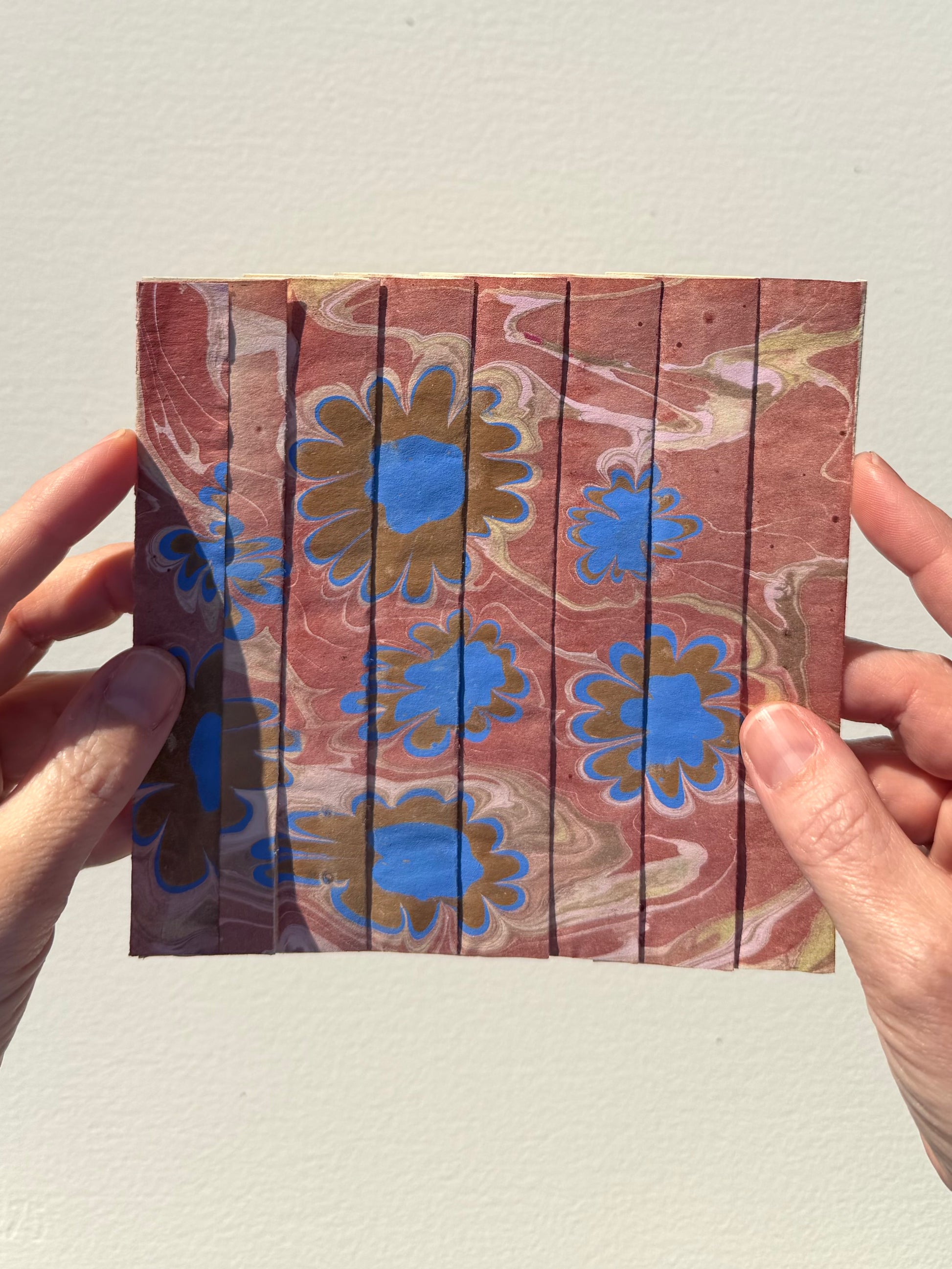 Ebru Pleat IV by Morgan Elvington Walker — original marbling on pleated newsprint paper, 6×6 in. Midnight Gallery.