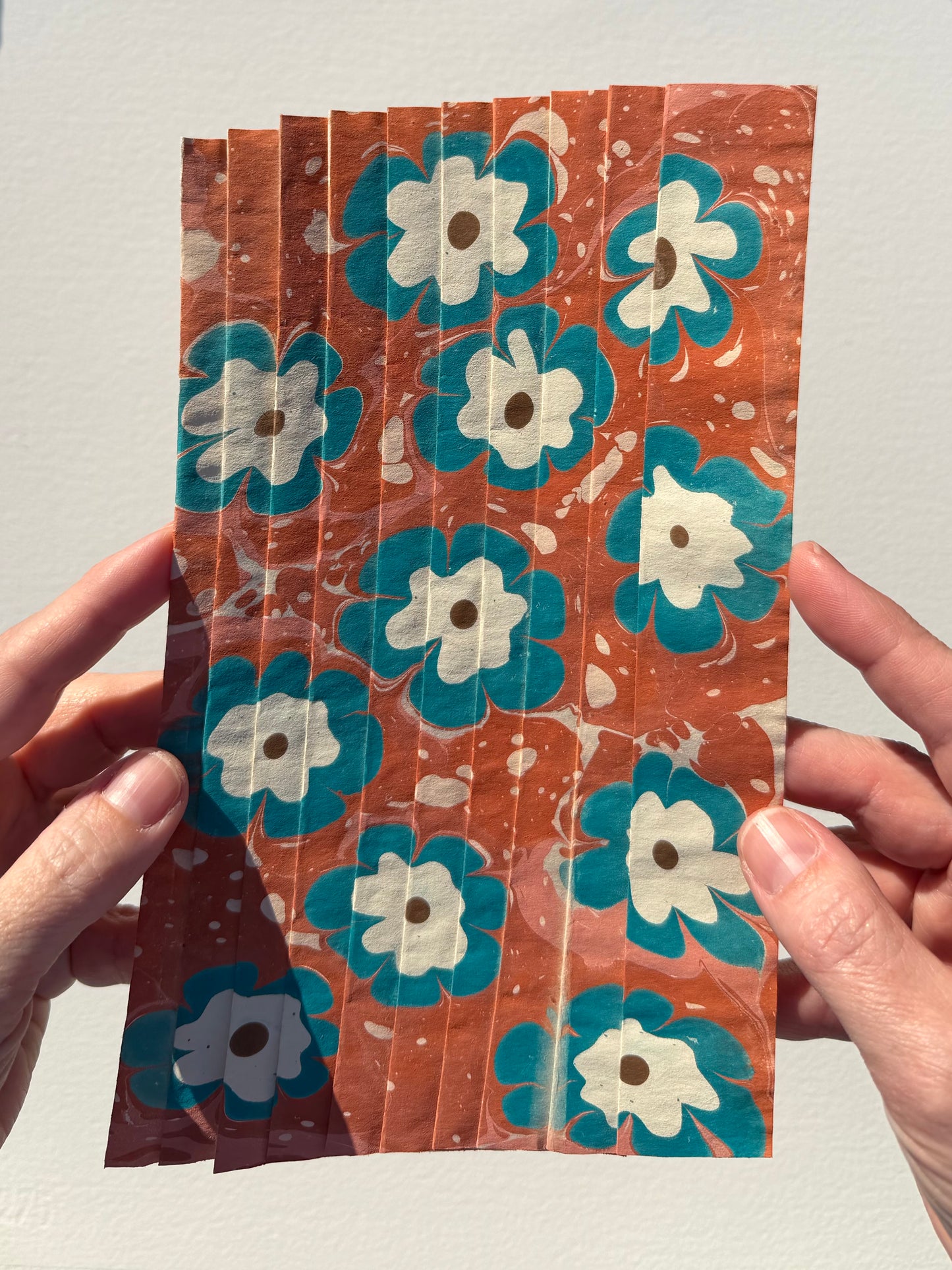 Ebru Pleat VIII by Morgan Elvington Walker — original marbling on pleated newsprint paper, 5.75×9 in. Midnight Gallery.