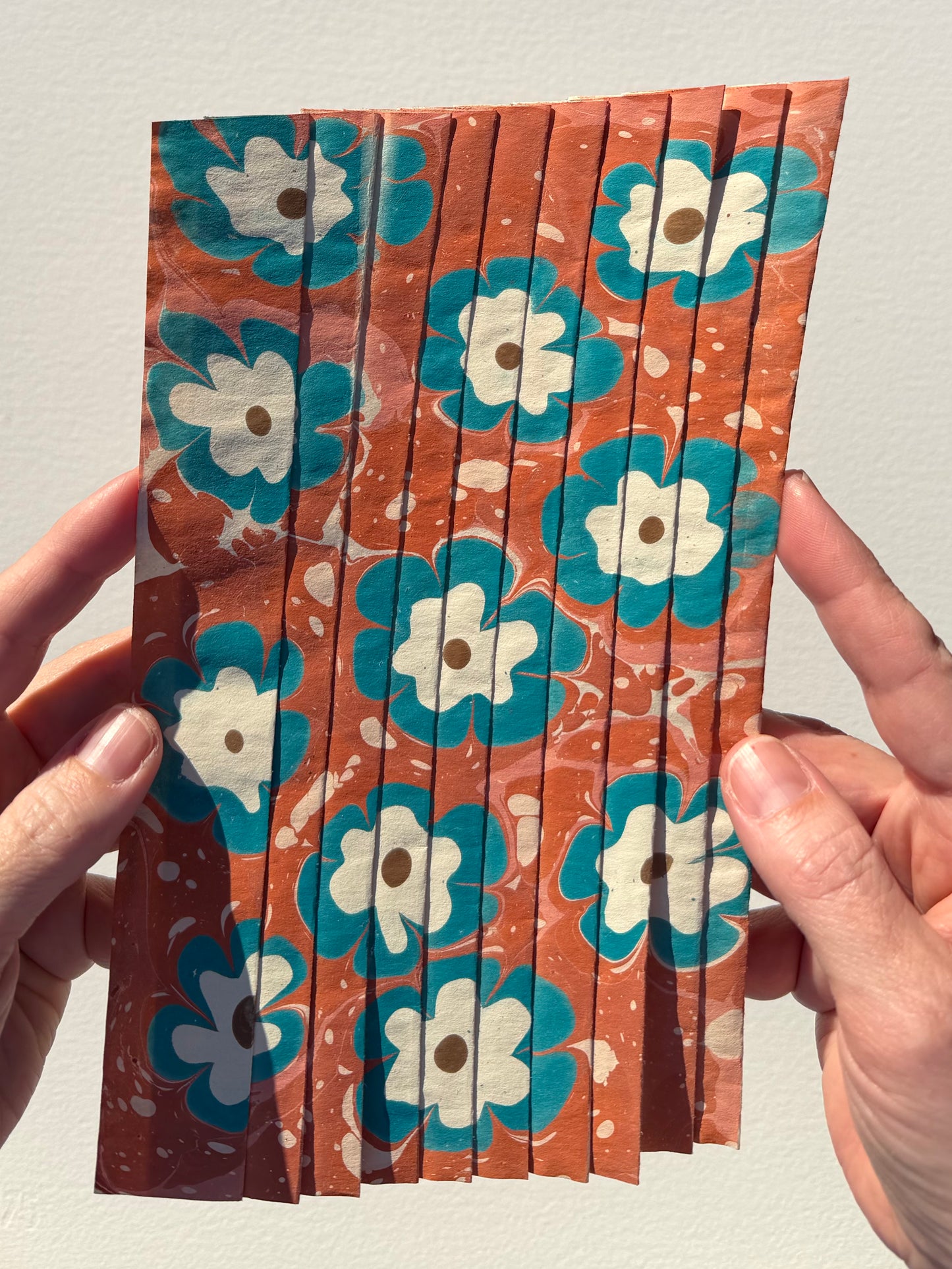 Ebru Pleat VIII by Morgan Elvington Walker — original marbling on pleated newsprint paper, 5.75×9 in. Midnight Gallery.