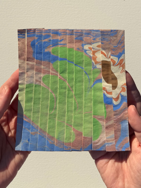 Ebru Pleat XVIII by Morgan Elvington Walker — original marbling on pleated newsprint paper, 5×6 in. Midnight Gallery.