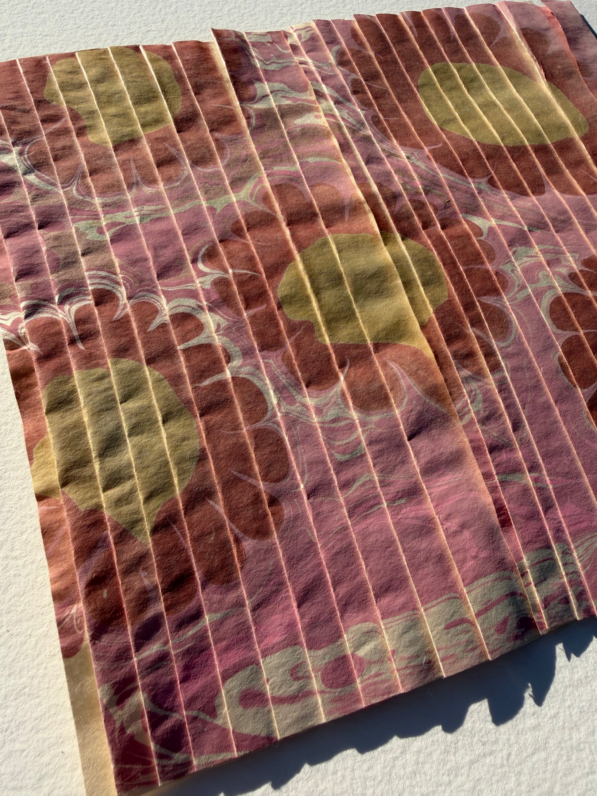 Ebru Pleat III by Morgan Elvington Walker — original marbling on pleated newsprint paper, 10×8.75 in. Midnight Gallery.