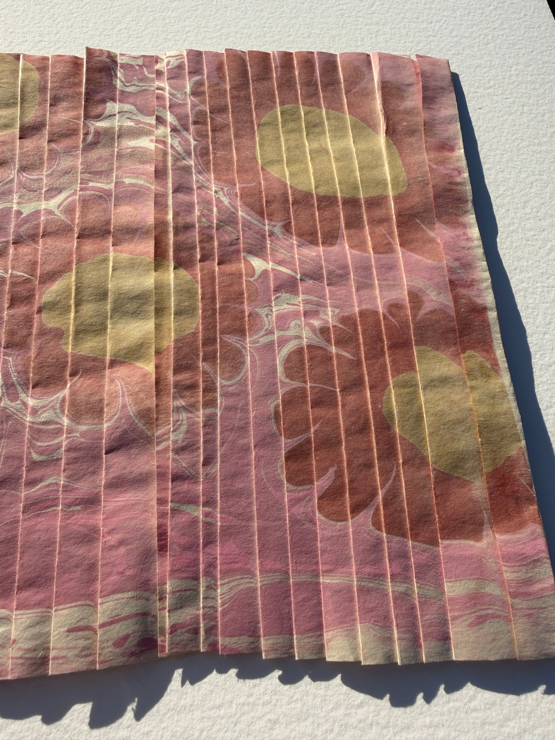 Ebru Pleat III by Morgan Elvington Walker — original marbling on pleated newsprint paper, 10×8.75 in. Midnight Gallery.