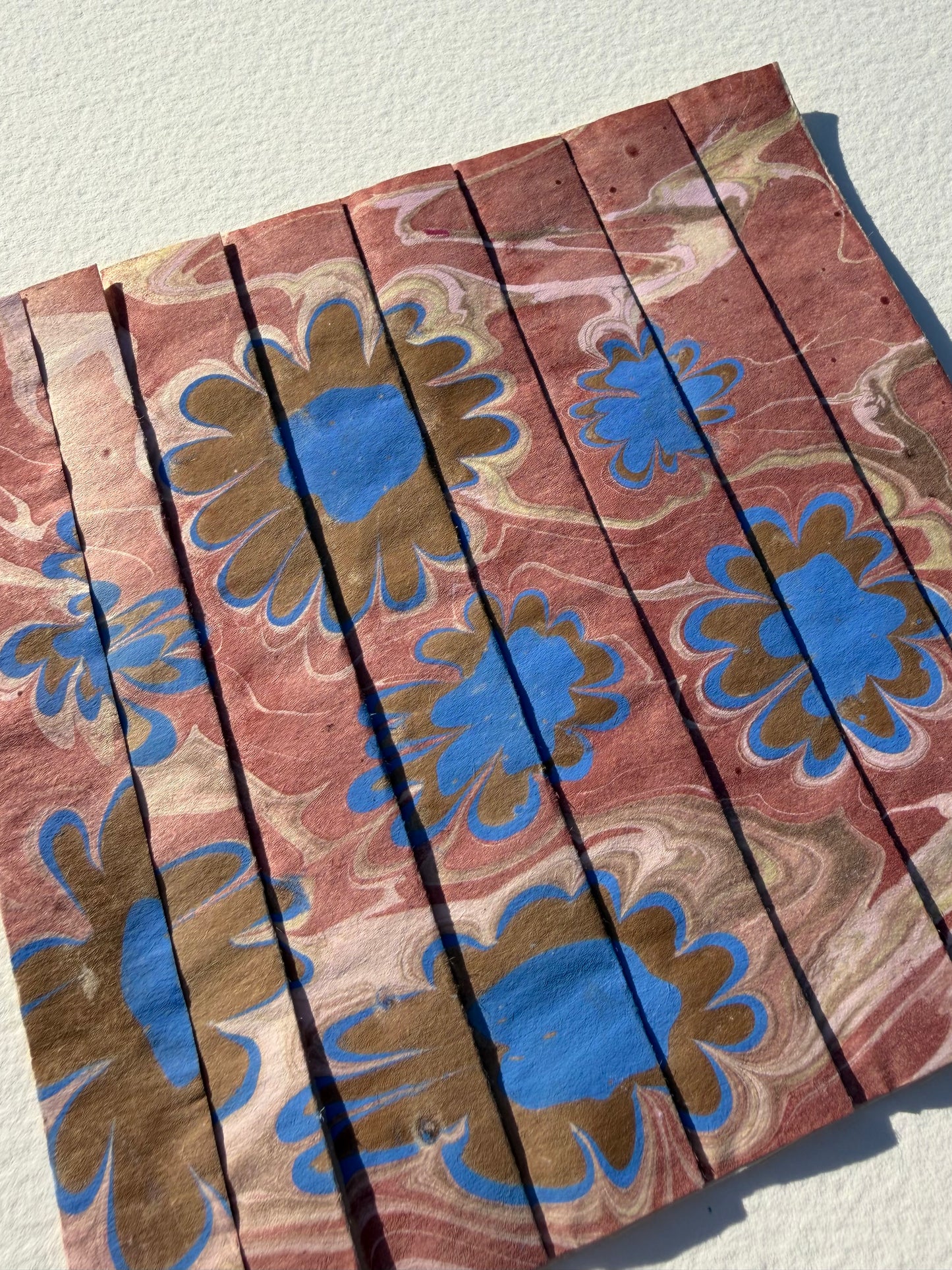 Ebru Pleat IV by Morgan Elvington Walker — original marbling on pleated newsprint paper, 6×6 in. Midnight Gallery.